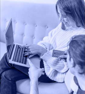 A women smiling and using her computer