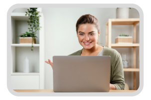 Woman in front of laptop, talking to someone in a virtual meeting.