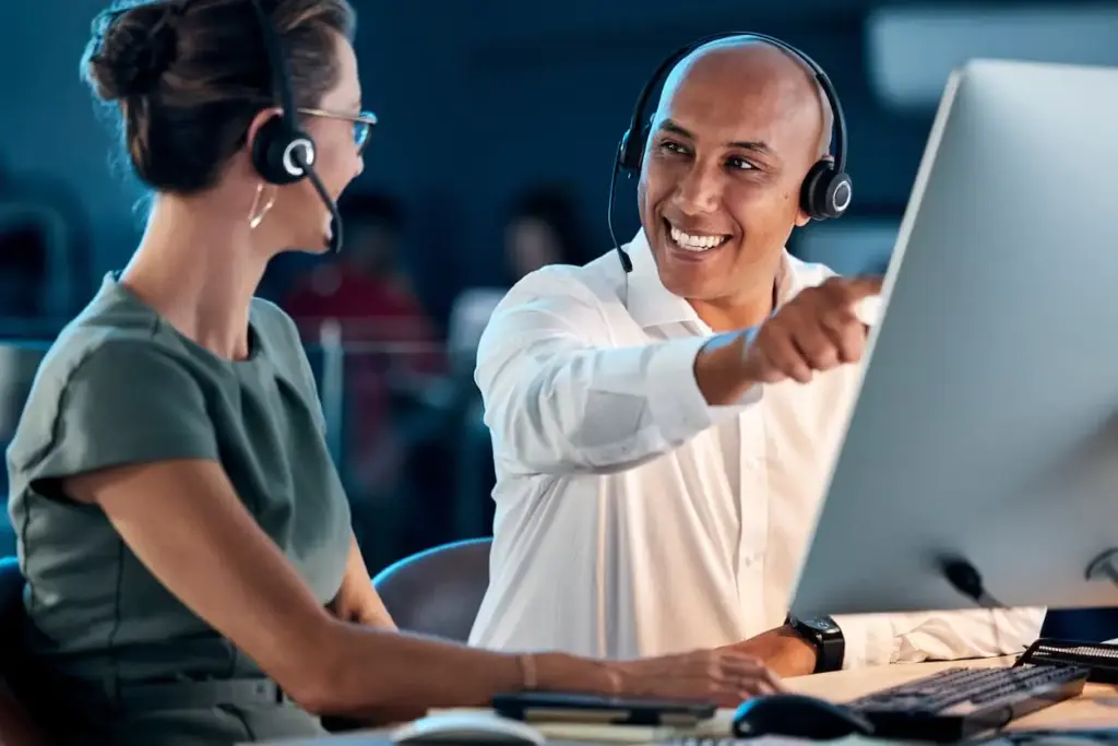 Two people wearing headphone with mic attached.